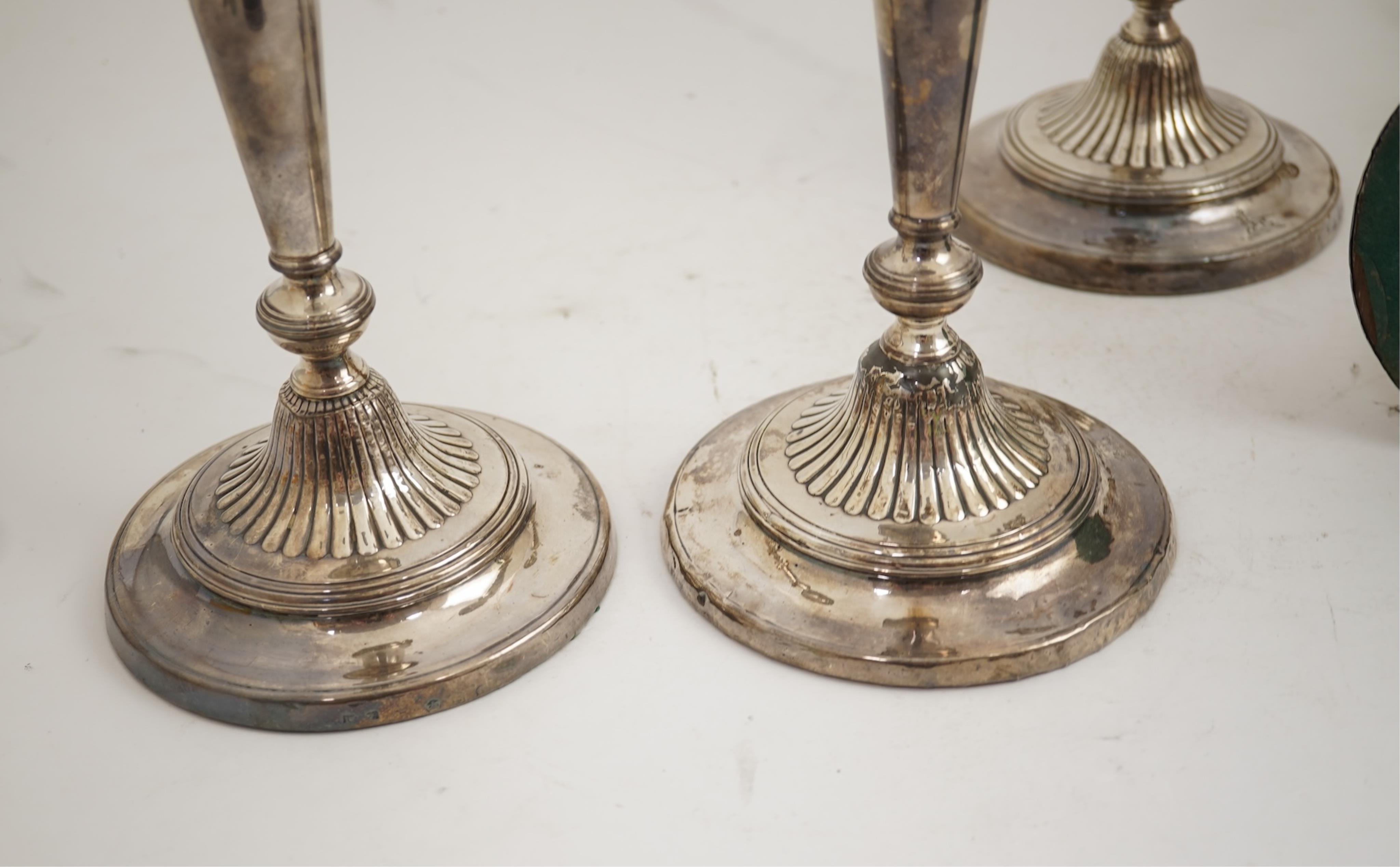 A set of four George III silver candlesticks by John Green, Roberts, Mosley & Co, with waisted turned stems, on circular foot, Sheffield, 1801, (repair), 27.5cm, loaded.